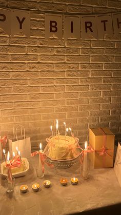 a birthday cake with lit candles on a table