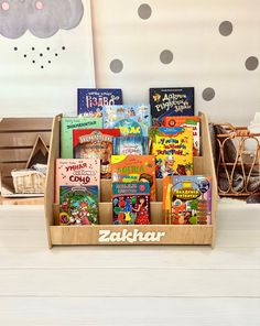 a wooden box filled with lots of children's books on top of a table