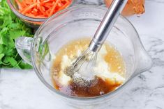 carrots and other vegetables are being mixed in a blender