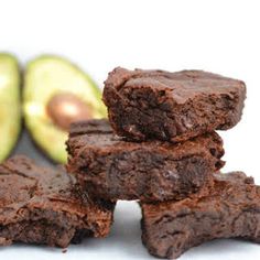 a pile of brownies next to an avocado