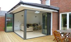 a patio area with chairs, table and sliding glass doors