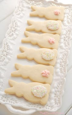 several decorated cookies sitting on top of a white tray