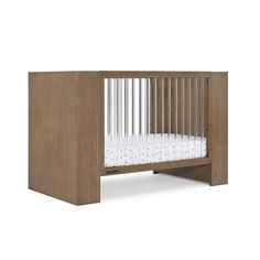 a wooden crib with white sheets in it