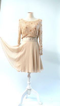 "Coolest dress...could be a wedding dress...or a guest of.. In a peach ivory with beautiful silkabsolutely stunning!! Excellent Beaded on tulle lined in silk Measuring: 36\" length Bust: 36\" Waist: 26\" Hip: 36\" + Sleeves: 22\" Pet Free/smoke free Enjoy!" Chic Beige Evening Dress For Wedding, Elegant Fitted Apricot Dress, Elegant Sheer Mother Of The Bride Dress, Summer Long Sleeve Mother Of The Bride Dress, Long Sleeve Summer Mother Of The Bride Dress, Summer Wedding Long Sleeve Mother Of The Bride Dress, Embellished Flowy Evening Dresses, Evening Flowy Embellished Dresses, Flowy Embellished Dresses For Evening