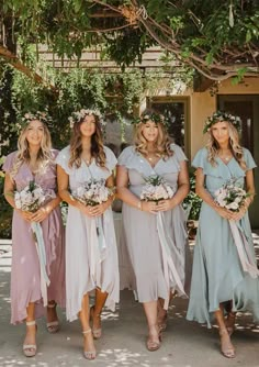 the bridesmaids are all dressed in pastel dresses and flower crowns for their wedding