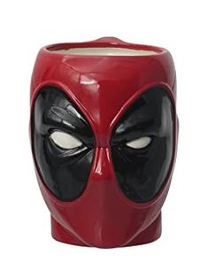 a close up of a red mug with a deadpool face on it