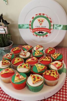 cupcakes are arranged on a plate with a red and white checkered tablecloth