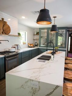 a kitchen with an island, stove and sink