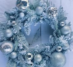 a christmas wreath with silver and silver ornaments