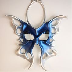 a blue mask hanging on the wall