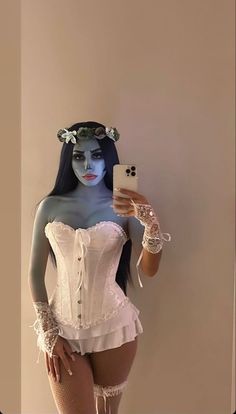 a woman in white corset taking a selfie