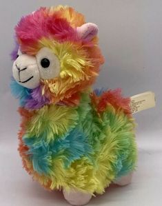 a stuffed llama with multicolored fur on it's back