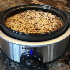 a crock pot filled with food sitting on top of a counter