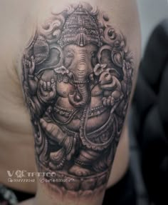 an elephant tattoo on the back of a man's arm