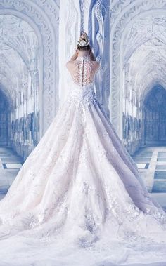 a woman in a white wedding dress standing next to a wall with arches and archways