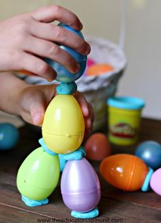 a child is playing with plastic toys on a wooden table in front of other play doughnuts