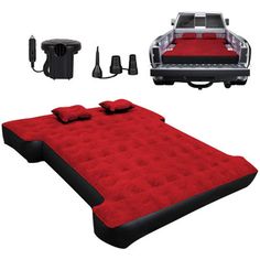 an inflatable bed with red pillows and black trimmings is next to a car