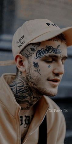 a man with tattoos on his face wearing a baseball cap and looking off to the side