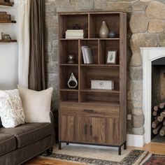 a living room with a couch, chair and bookcase in front of a fireplace