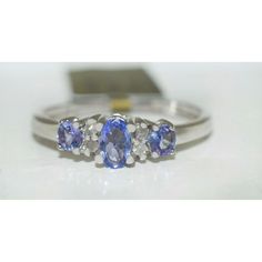 three stone ring with diamonds and blue sapphires