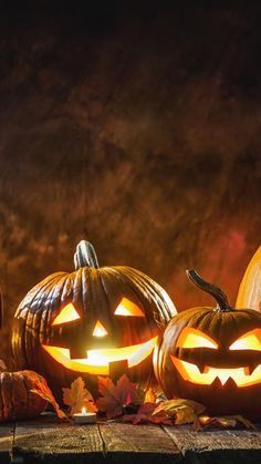 three carved pumpkins sitting next to each other