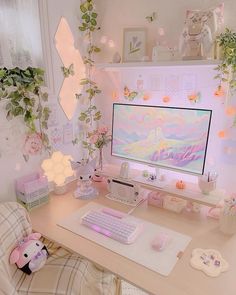 a desk with a computer, keyboard and mouse on it in front of some plants