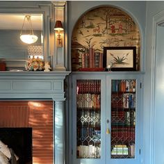 a room with a fireplace and bookshelves in it