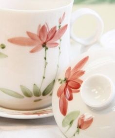 a tea cup and saucer sitting on top of a table