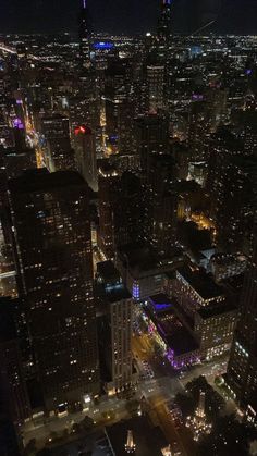 an aerial view of the city lights at night from high up in the skyscrapers