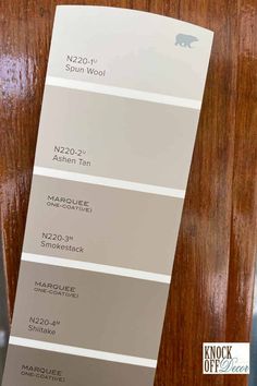 the shades of gray and white are used in this wood paneled wall color scheme