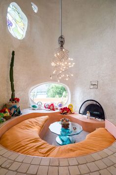 a living room filled with furniture and a fire place in the corner next to a window