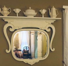 a mirror that is on the side of a wall