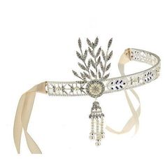 a white headband with an elaborate brooch