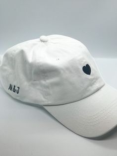 White or black, adjustable baseball cap perfect for an engagement gift, a bridal shower, or bachelorette party. Customizable first name initials on the side of the cap. Use promo code SAVEHATS to save 10% on 5 or more hats! Please note- all custom hats require at MOST 14 days to process, as each hat is made to order. This does not include shipping time. Based on the volume of orders at the time, this processing time may be shortened! If you are working on a timeline, be sure to message me so we Wedding Baseball Hat, Bach Gifts, Bach Gift, Cap Code, White Baseball Hat, Custom Baseball Hats, Bachelorette Hats, White Baseball Cap, Personalized Hats