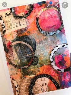 an art journal with mixed media and paper collages on the cover, including circles