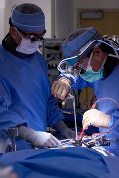 two doctors performing surgery in an operating room