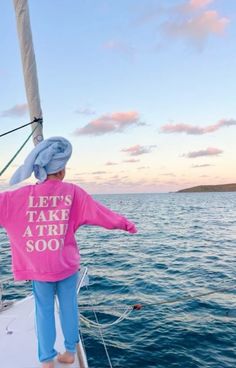 a person standing on the back of a boat