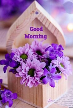 purple flowers in a wooden box with the words good morning