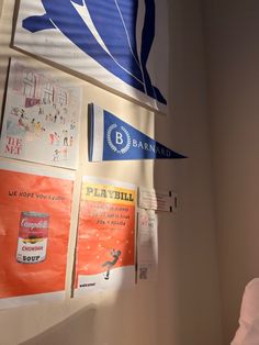 there are many posters on the wall with blue and white flags hanging from it's sides