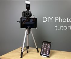 a camera sitting on top of a tripod next to a cell phone with the words diy photo booth