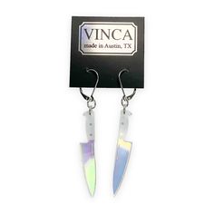 If you're a fan simple yet stunning things then these are the earrings for you. Our Midi 2" Knife Dangle Earrings in transparent iridescent are cut from acrylic. Two inch Hologram Knife charms are on a 1" surgical steel hinged hook. Transparent iridescent acrylic Sold as a pair 2" knife charms on surgical steel hinged hooks Hidden Knives, Iridescent Acrylic, Candle Cards, Body Stickers, Book Candle, Fish Hook Earrings, Shoe Gifts, Curated Gifts, Gift Stickers