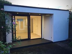 a small white building with sliding glass doors