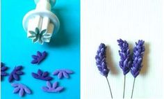 some purple flowers are sitting next to a white object and one is made out of fondant