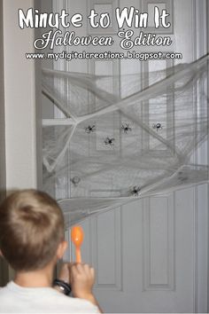 a young boy holding an orange object in front of a white door with spider web on it