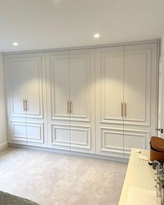 a bedroom with white cabinets and carpeted flooring