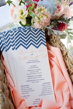 a bouquet of flowers sitting on top of a table next to a blue and white menu