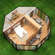 an aerial view of a tiny house on the grass with its living room and kitchen