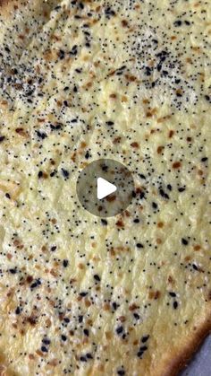 a cheese pizza with black speckles on it