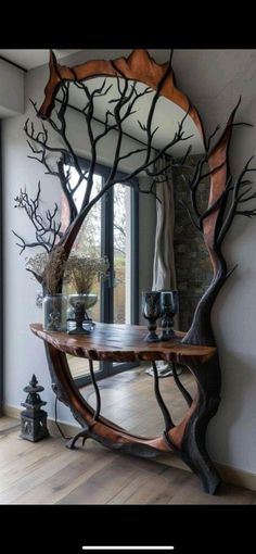 a wooden table sitting in front of a mirror on top of a hard wood floor