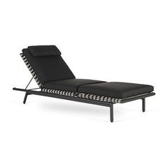 a black chaise lounge chair with white and black stripes on the backrests